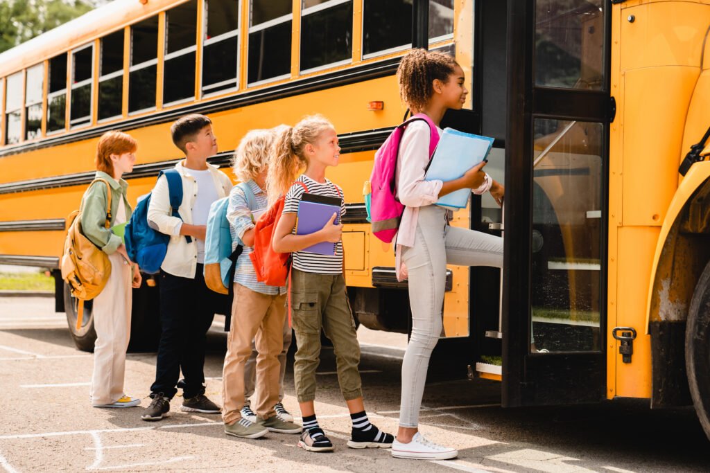 Children standing in a line to hop on bus